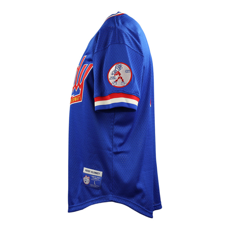 The EFF Reddy Kilowatt EFF DNA Replica V-Neck Mesh Jersey is shown from the side, with red and white striped sleeves, a Reddy Kilowatt safe electricity patch on the right sleeve, and stitched labels near the bottom hem.