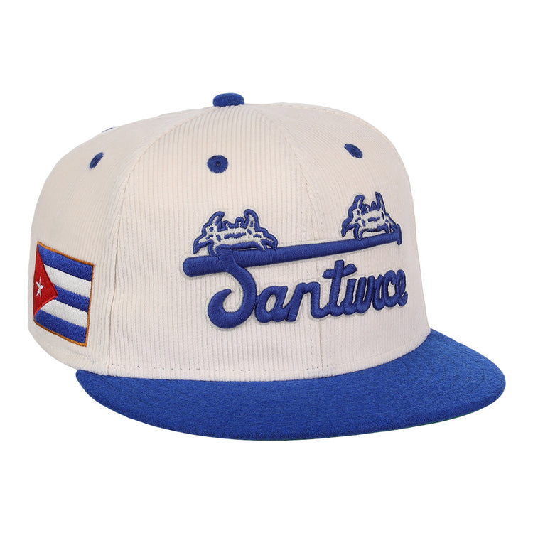 The EFF Santurce Cangrejeros NLB Ground Rule Double Fitted Ballcap is a vintage-inspired cream and blue cap with Santurce in blue script, two crabs above, and the Cuban flag on the side.