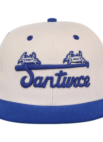 The EFF Santurce Cangrejeros NLB Ground Rule Double Fitted Ballcap features a beige crown, blue brim, Santurce script, blue crab graphics above a bat, and side stripes—ideal for Puerto Rican League fans.