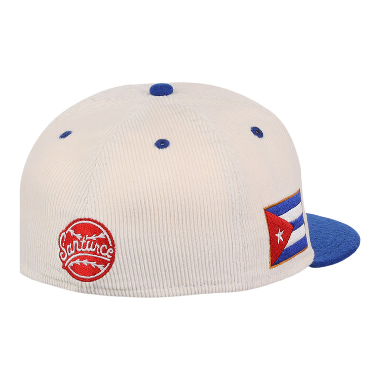 The EFF Santurce Cangrejeros NLB Ground Rule Double Fitted Ballcap is a white corduroy vintage-style hat with blue accents, featuring a red Santurce patch and Cuban flag patch, honoring Puerto Rican League heritage.