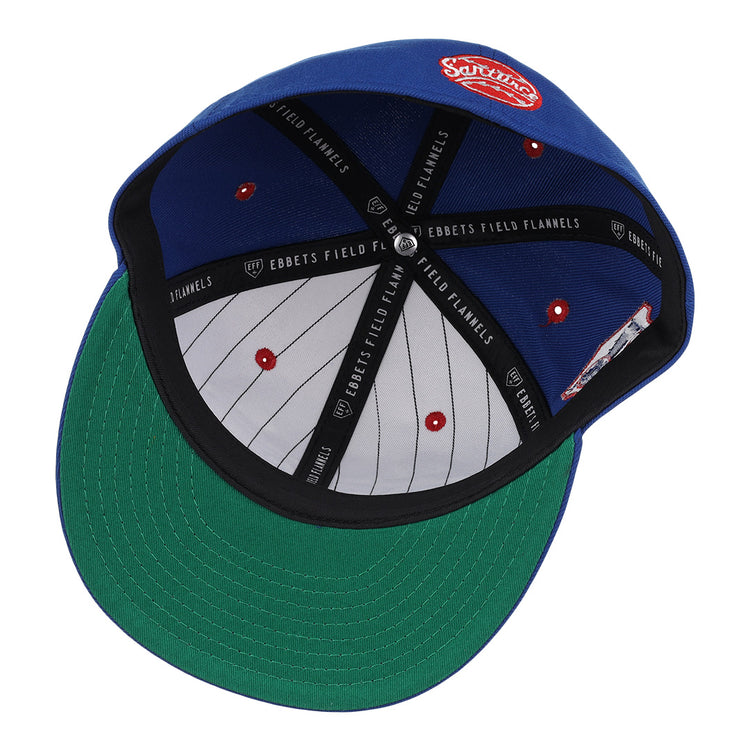The Santurce Cangrejeros NLB Team Color Fitted Ballcap by EFF features a blue vintage-inspired design, green undervisor, gray crown with red eyelets, black EBBETS FIELD FLANNELS taping, and a red-and-white patch on top.