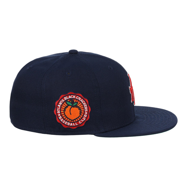 The EFF Atlanta Black Crackers NLB Team Color Fitted Ballcap in navy features a red and orange side patch reading Atlanta Black Crackers Baseball Club around an orange baseball, inspired by classic Negro Southern League styles.