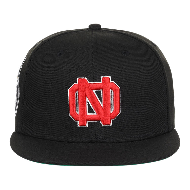 The EFF New Orleans Black Pelicans NLB Team Color Fitted Ballcap in black features a red and white embroidered interlocking N and D logo, inspired by the Negro Southern League’s vintage team style.