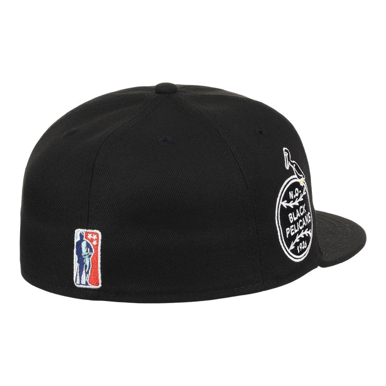 The EFF New Orleans Black Pelicans NLB Team Color Fitted Ballcap in black features a round team patch on the side, a small red, white, and blue baseball player logo near the back, and a flat brim.