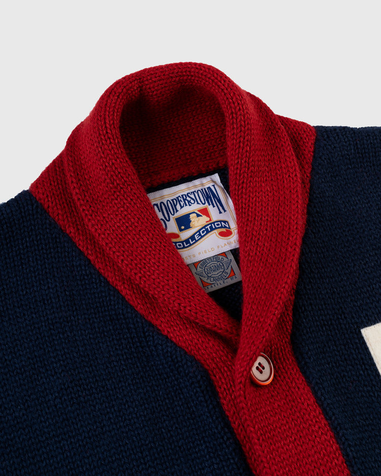 Close-up of EFF’s Boston Braves 1915 Wool Shawl Collar Sweater—a navy and red buttoned reproduction from the Cooperstown Collection, featuring a red collar, white detailing, and a single white button for classic style.