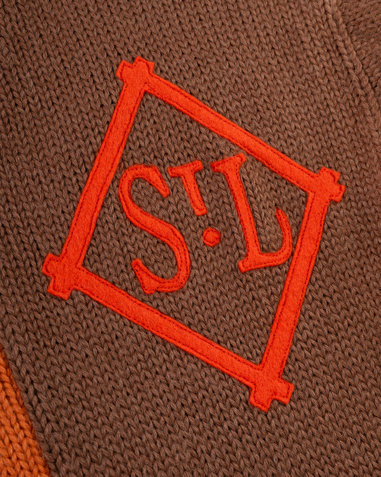 Close-up of the EFF St. Louis Browns 1909 Wool Cardigan Sweater, a brown knit inspired by vintage styles, with an orange embroidered STL patch inside a square border.