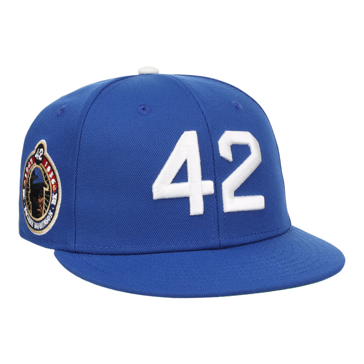 The EFF Jackie Robinson Signature Series Royal Fitted Ballcap features a white 42 on the front and a side patch with Jackie Robinson’s image and number—honoring his enduring legacy.