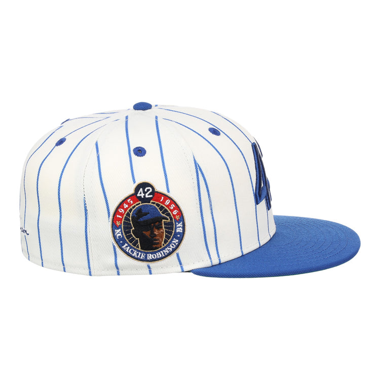 The EFF Jackie Robinson EFF Signature Series Fitted Ballcap - Pinstripe features blue pinstripes, a blue brim, and a circular Jackie Robinson tribute patch with 42 and his silhouette.