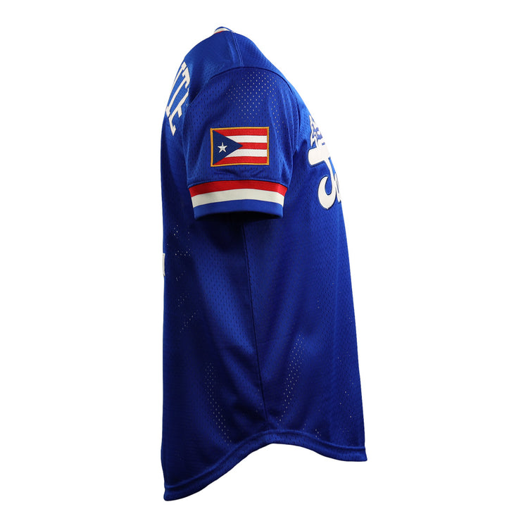 The EFF Roberto Clemente Santurce Cangrejeros Vintage Inspired NL Replica V-Neck Mesh Jersey in royal blue with white lettering and a Puerto Rican flag patch is shown on a mannequin from a side angle.