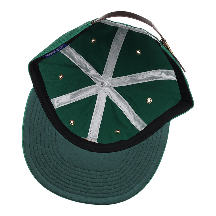 The EFF Hot Springs Bathers Cotton Twill Ballcap in green is shown inside-out, featuring a black sweatband, white interior seams, metal rivets, and a brown adjustable leather strap.