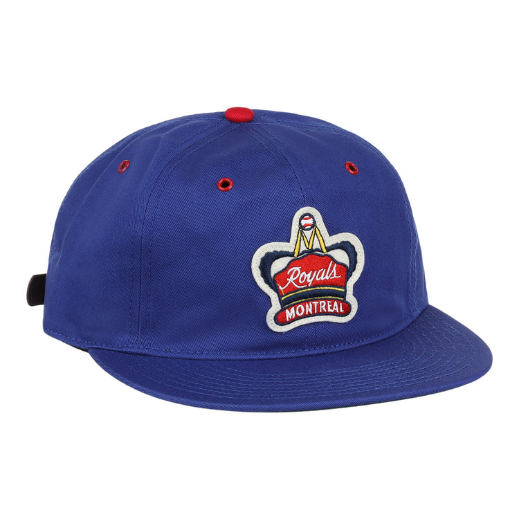 The EFF Montreal Royals Cotton Twill Ballcap is blue cotton with a red top button, red eyelets, and an embroidered Royals Montreal patch featuring a crown on the front.
