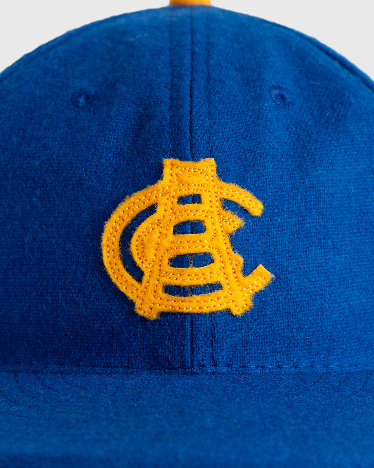 Close-up of the EFF Chinese Athletic Club (Hawaii) 1910 Authentic Wool Ballcap—blue wool with a yellow vintage-style embroidered C and A logo, inspired by historic Hawaii baseball and the original club cap.