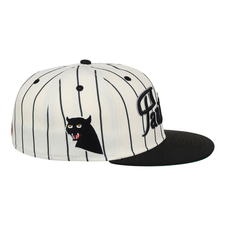 The EFF Montreal Black Panthers NLB Pinstripe Fitted Ballcap features black vertical pinstripes on white, a black brim, and an embroidered black cat face with red eyes and fangs on the side.