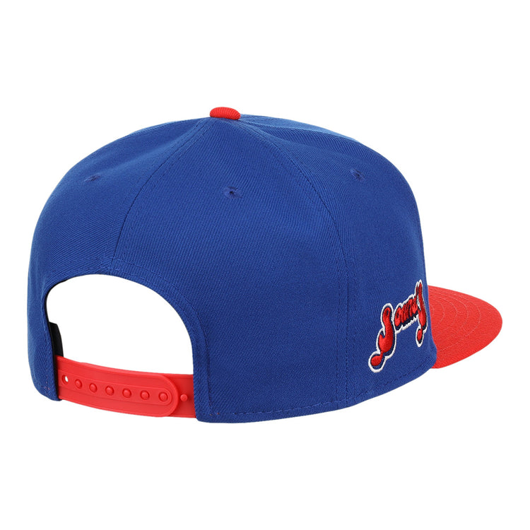 The Ebbets Field Flannels Nashville Sounds EFF MiLB Vintage Snapback features a blue crown, red brim, red adjustable strap, and side red and white embroidered textâan eye-catching cap from the Vintage Minor League collection.