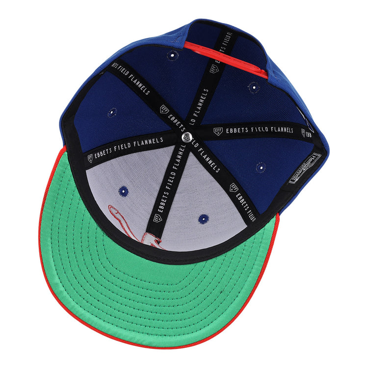 The Nashville Sounds EFF MiLB Vintage Snapback by Ebbets Field Flannels features a blue exterior, green underside brim, red trim, black bands labeled EBBETS FIELD FLANNELS, and is part of the Vintage Minor League collection.