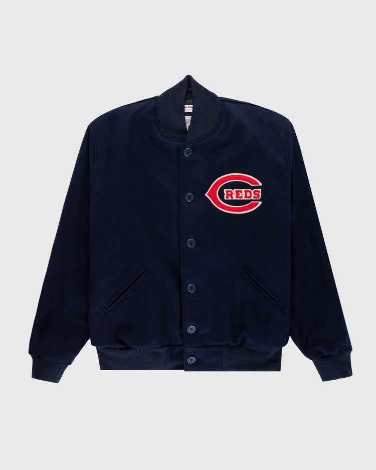 The EFF Cincinnati Reds 1942 Authentic All Wool Varsity Jacket features a navy design with ribbed cuffs and hem, button-up front, slanted pockets, and a large red and white C patch with REDS on the chest, inspired by vintage Reds style.