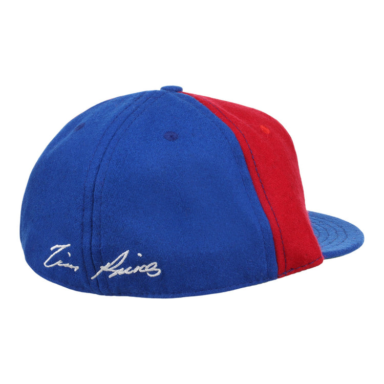 The Ebbets Field Flannels Tim Raines Signature Series Ballcap is a vintage wool cap in blue and red, with two panels of each color and a white Tim Raines signature embroidered on the blue section near the back.