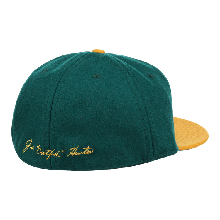 The Catfish Hunter Signature Series Ballcap by Ebbets Field Flannels features green vintage wool, a yellow brim and button, and gold J.G. Catfish Hunter embroidery—perfect for National Baseball Hall of Fame fans.