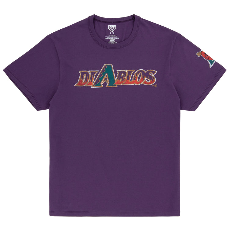 The Ebbets Field Flannels El Paso Diablos EFF MiLB Vintage T-Shirt is a purple premium cotton tee with Diablos in stylized chest text, a graphic logo as the letter A, and a colorful left sleeve patch inspired by vintage minor league shirts.