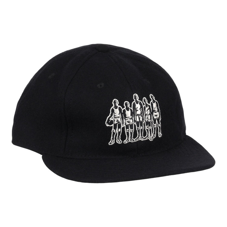 The Black Fives Wool Ballcap by Ebbets Field Flannels is a black vintage-inspired baseball cap featuring a white outline graphic of five people standing in a row on the front, celebrating the legacy of the Black Fives.