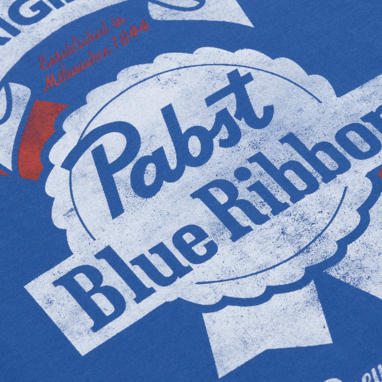 Close-up of the PBR EFF Vintage Beer T-Shirt in royal blue by Ebbets Field Flannels, featuring a distressed vintage-style Pabst Blue Ribbon logo with white and red accents and Established in Milwaukee 1844.