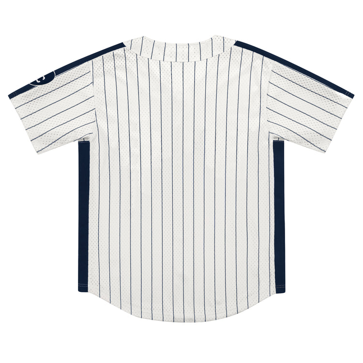 The EFF Kansas City Monarchs NLB Pinstripe Button Down Jersey features white fabric with thin navy blue pinstripes, navy side panels, and a round neckline. Shown from the back, its inspired by classic Ebbets Field Flannels jerseys.