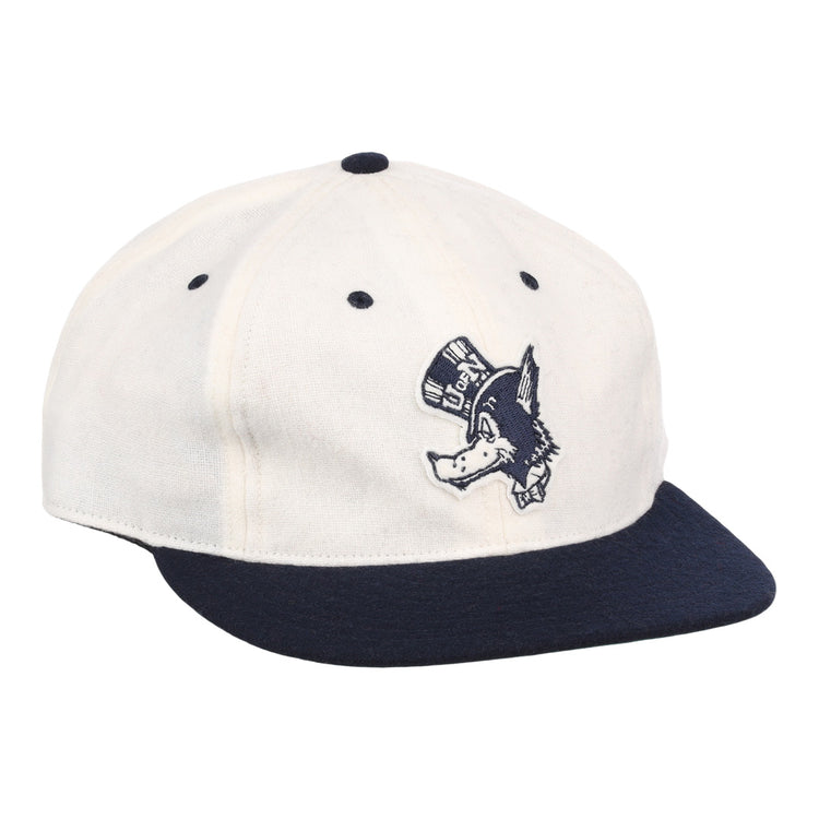 The EFF University of Nevada Wolf Pack Mascot Collegiate Wool Ballcap in white features a navy brim and button, plus an embroidered Wolf Pack logo—perfect for standout collegiate style.
