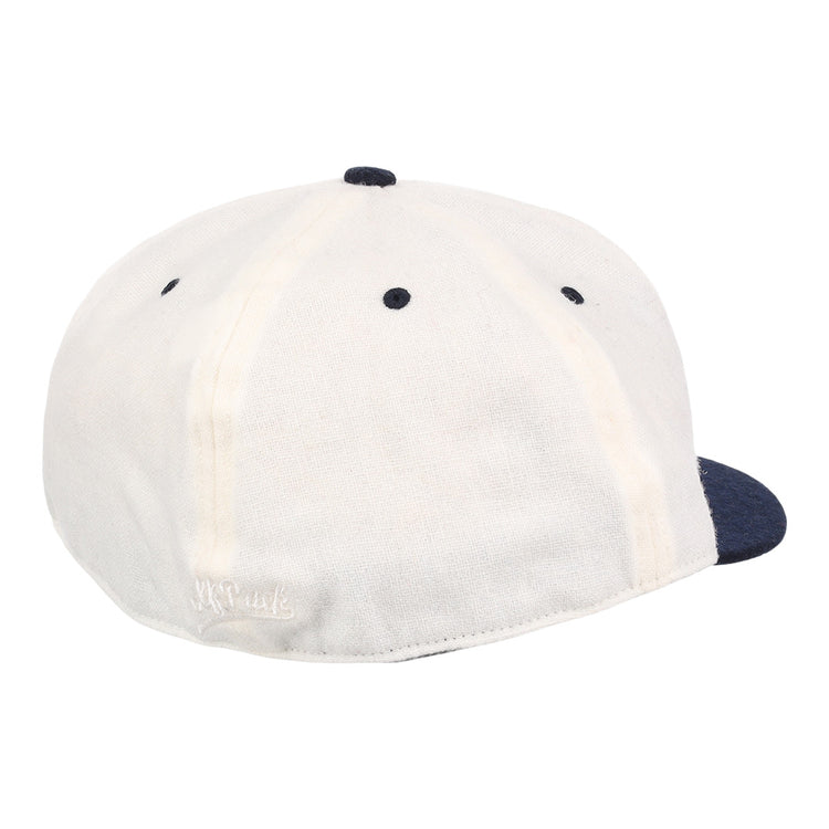 A white EFF University of Nevada Wolf Pack Mascot Collegiate Wool Ballcap with a navy blue button and brim, shown from the back on a white background. Features visible stitching and a small embroidered logo near the bottom edge.