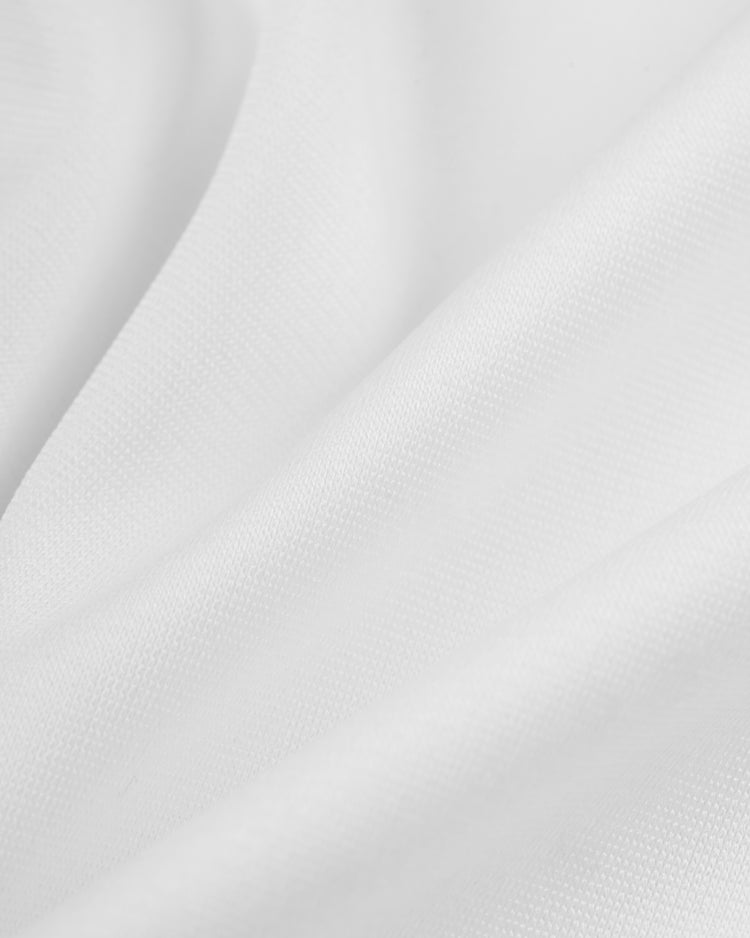 Close-up of the soft, white fabric and textured weave of the EFF Walla Walla Padres Mesh V-Neck Jersey—echoing the classic jerseys worn by Ozzie Smith with the St. Louis Cardinals and San Diego Padres.
