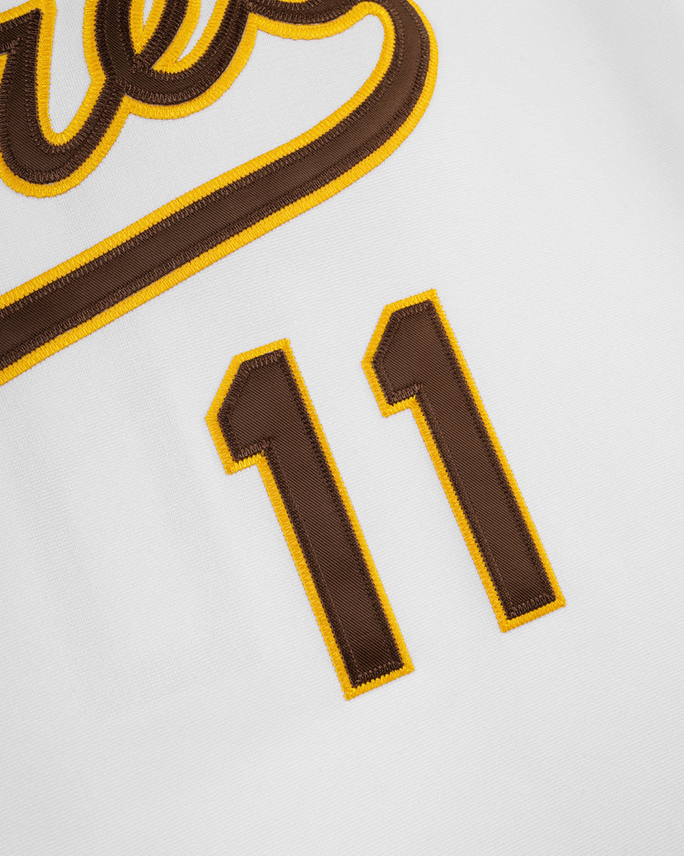 Close-up of the EFF Walla Walla Padres Mesh V-Neck Jersey in white, showcasing brown “11” numbers with yellow trim and a brown and yellow script logo—classic style inspired by Ozzie Smith’s San Diego Padres era.