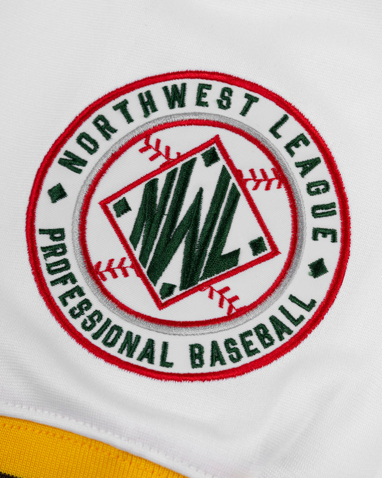 The EFF Walla Walla Padres Mesh V-Neck Jersey features a circular patch with Northwest League Professional Baseball, a red diamond center with green NWL letters and red stitches, sewn onto white fabric—evoking classic baseball memorabilia.