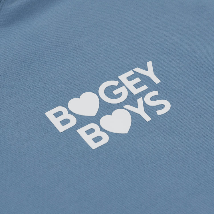 The EFF Bogey Boys x EFF French Terry Hoodie features “BOGEY BOYS” in white with heart-shaped O’s, making this blue premium fleece a standout golf apparel piece.