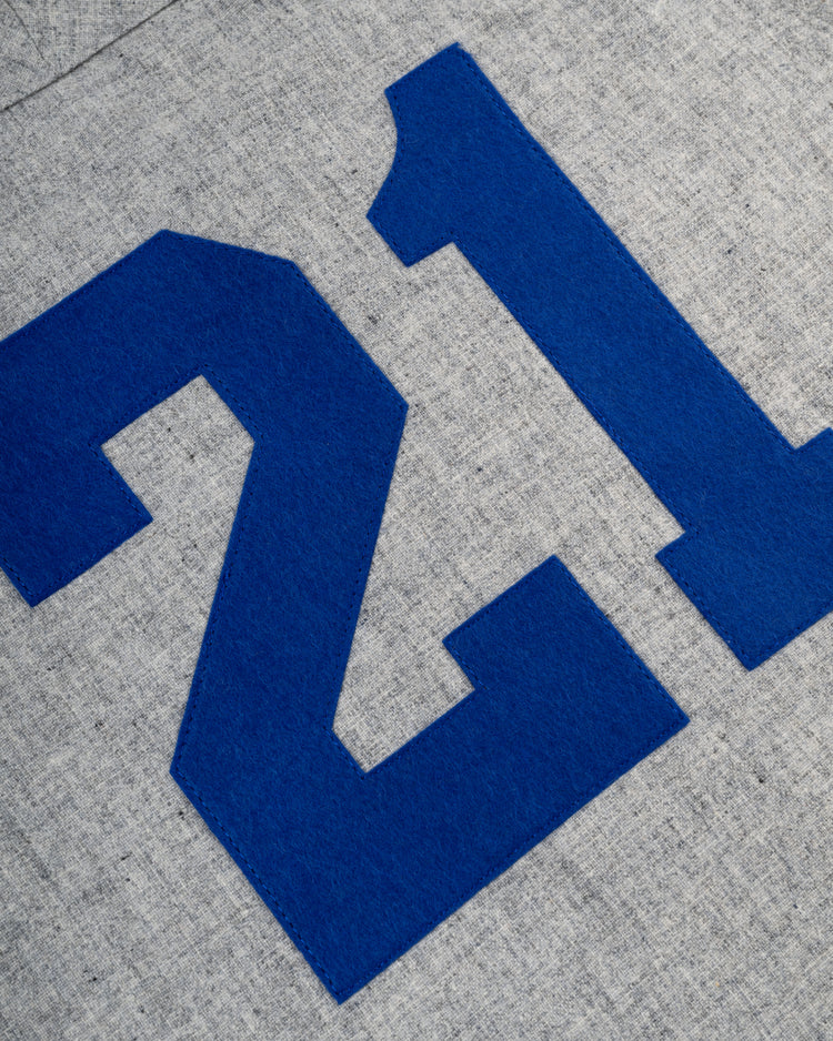 Blue number 21 printed on textured gray wool fabric, inspired by the Santurce Cangrejeros 1954 Authentic Road Baseball Jersey from Ebbets Field—a tribute to classic Santurce baseball style.