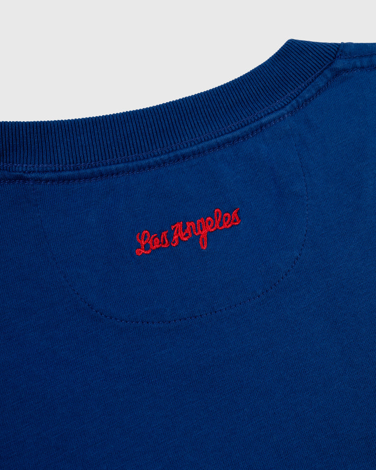 A close-up of the back neckline of the Ebbets Field Los Angeles Angels (PCL) Embroidered ‘LA’ Short Sleeve Tee, featuring ‘LA’ stitched in red, inspired by the 1942 team logo.