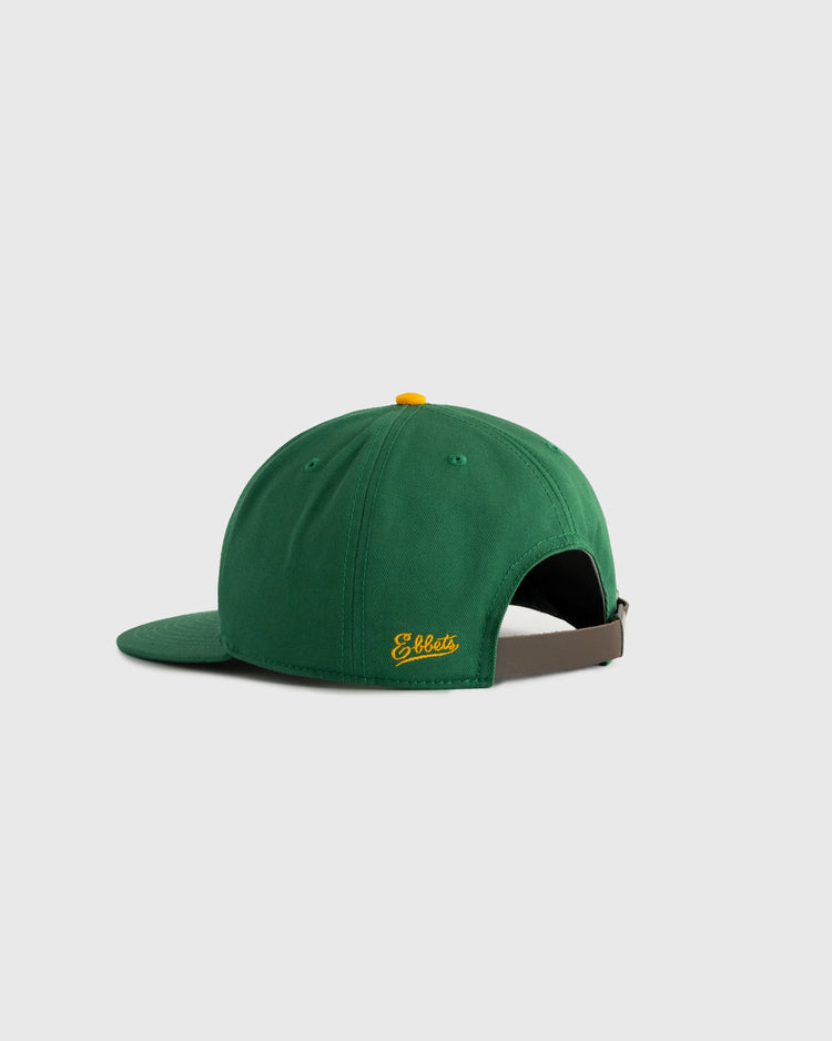 The Hawaii Islanders (PCL) Cotton Twill Ballcap by Ebbets Field is a green vintage-style hat with a yellow top button, yellow Ebbets text on the back, and an adjustable brown strap, shown from the rear against a plain light background.