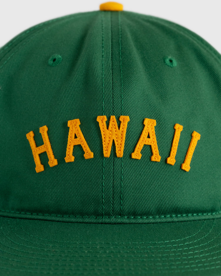The Ebbets Field Hawaii Islanders (PCL) Cotton Twill Ballcap is a vintage green hat with yellow HAWAII embroidery on the front, made from durable cotton twill.