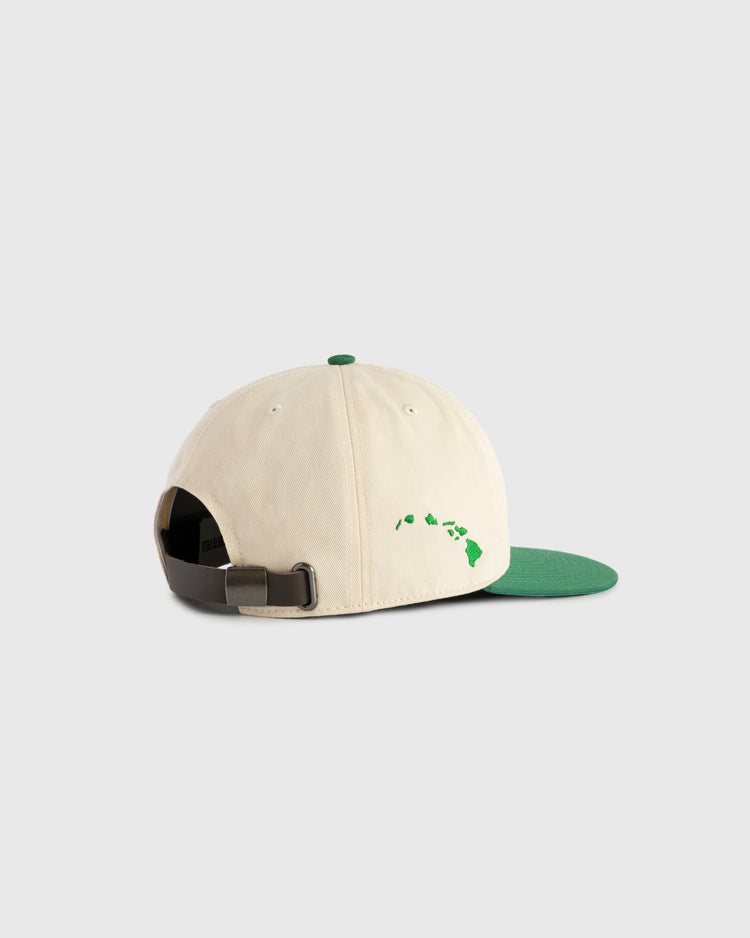 The Ebbets Field Hawaii Islanders (PCL) Cotton Twill Ballcap is a beige vintage hat with a green brim and top button, green Hawaiian Islands outline on the back, and features an adjustable strap with metal buckle for comfort and style.