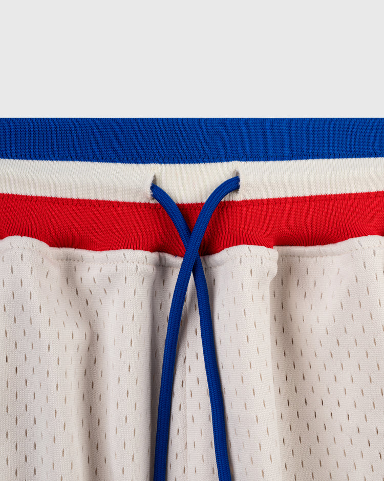 Close-up of the waistband on Ebbets Field Santurce Cangrejeros Mesh Shorts, featuring a blue drawstring, red stripe, blue elastic top, and perforated holes for breathability. Design inspired by Puerto Rican baseball legends like Roberto Clemente.