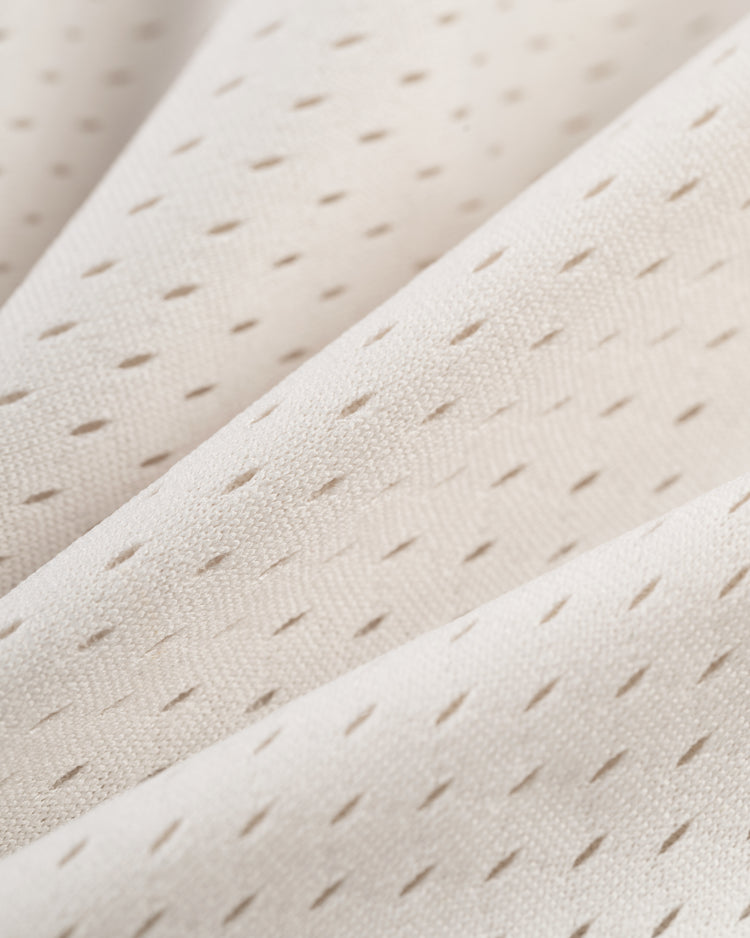 Close-up of the Ebbets Field Hawaii Islanders (PCL) Mesh V-Neck Jersey reveals cream-colored mesh fabric with small perforations and soft folds, giving it a textured, vintage-inspired look.