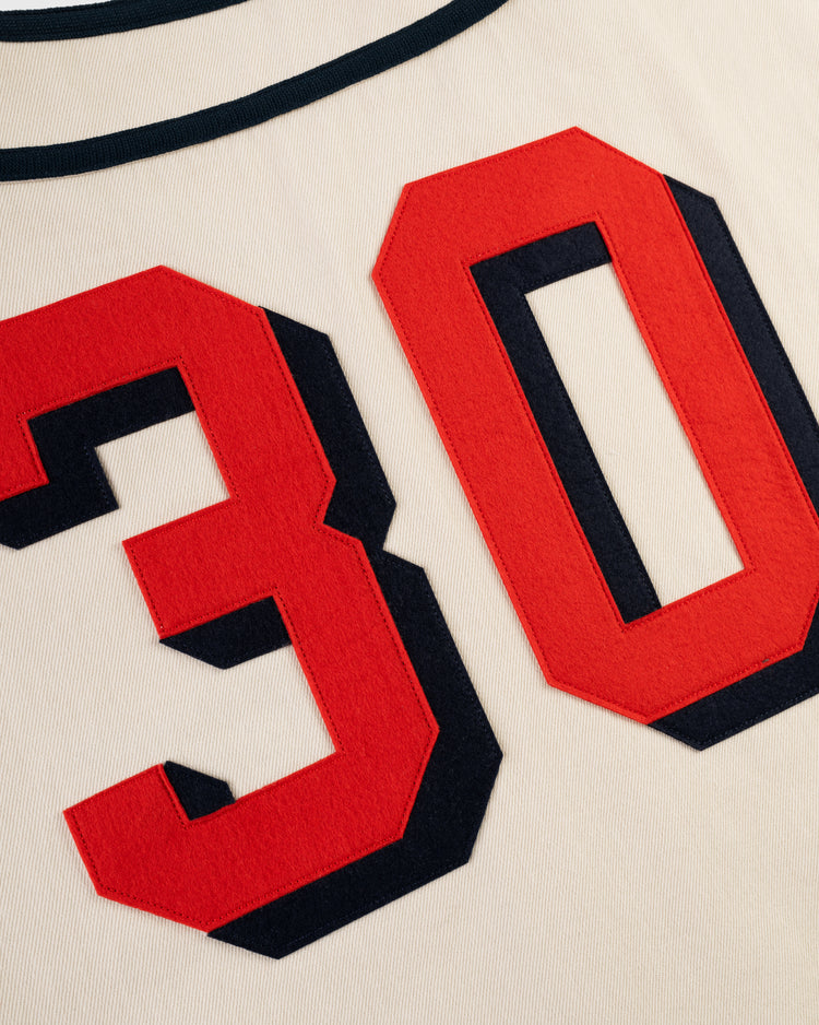 Close-up of the cream Los Angeles Angels (PCL) Cotton Twill Jersey by Ebbets Field, featuring large red numbers 30 with black outlines sewn onto the vintage-style fabric.