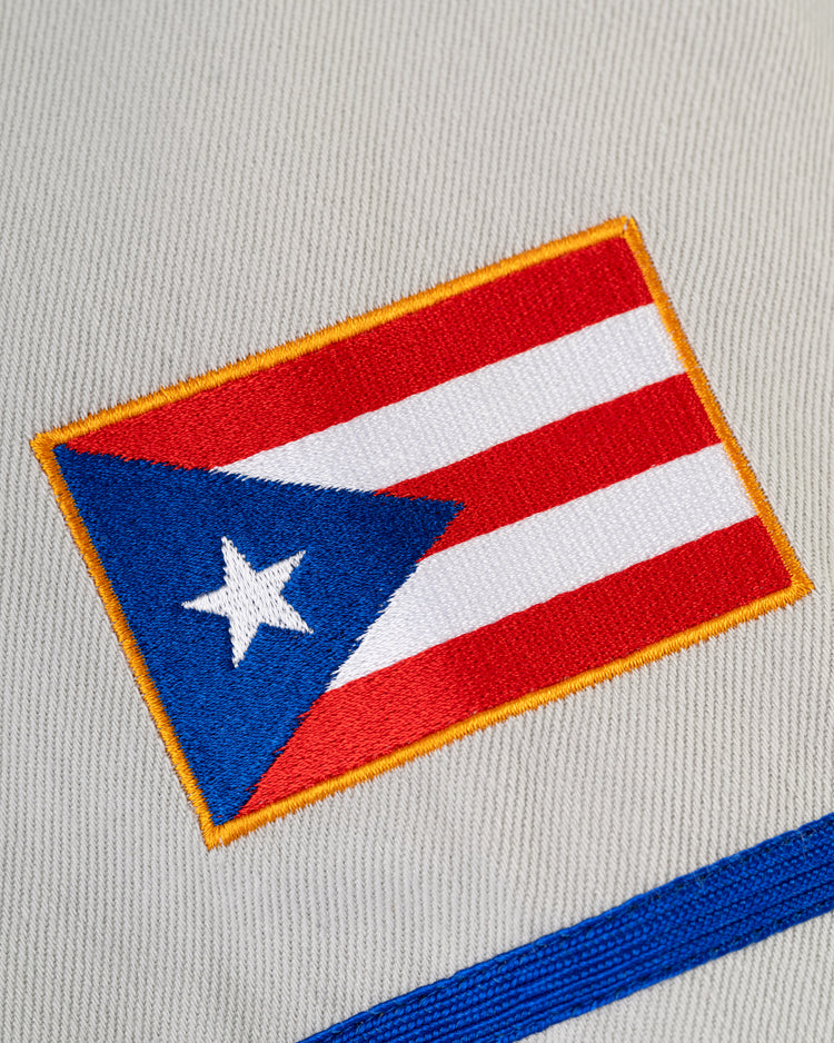 Close-up of the embroidered Puerto Rican flag patch on the Ebbets Field Puerto Rico 1958 National Team Cotton Twill Baseball Jersey, inspired by vintage designs and Roberto Clemente’s classic style.
