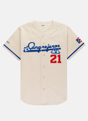 The Ebbets Field Santurce Cangrejeros Cotton Twill Baseball Jersey features cream cotton twill, blue script, a red 21, blue trim, and a Puerto Rican flag—an iconic Roberto Clemente collectible for any jersey fan.