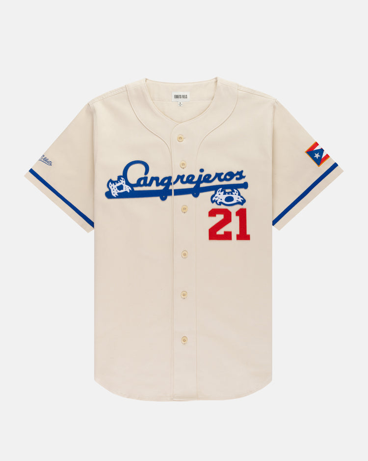 The Ebbets Field Santurce Cangrejeros Cotton Twill Baseball Jersey features cream cotton twill, blue script, a red 21, blue trim, and a Puerto Rican flag—an iconic Roberto Clemente collectible for any jersey fan.