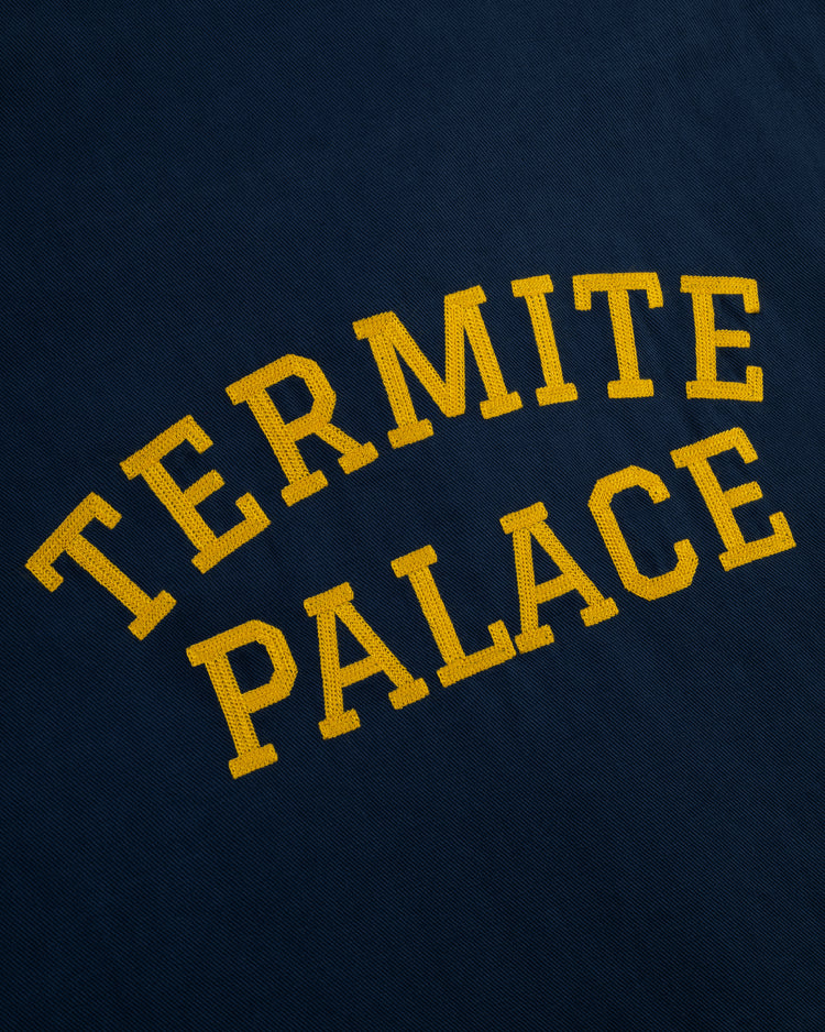 Yellow, uppercase text reading HAWAII ISLANDERS is displayed in a curved arrangement on the dark blue cotton linen blend fabric of the Ebbets Field Hawaii Islanders (PCL) Grounds Crew Short Sleeve Workshirt.