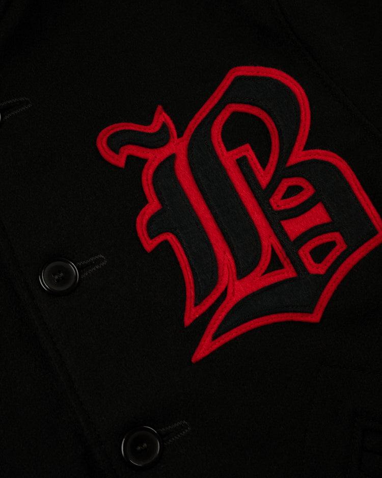 Close-up of the EFF Birmingham Black Barons 1940 Authentic All Wool Varsity Jacket, featuring a large red and black embroidered B and black buttons.