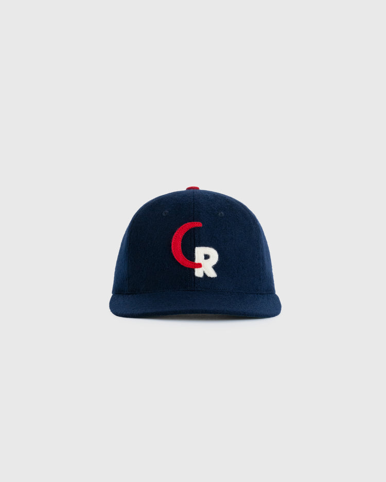 The EFF Caguas-Rio Piedras Criollos 1956-57 Authentic Wool Ballcap is navy blue, with a red and white CR logo on the front, shown against a plain light gray background.