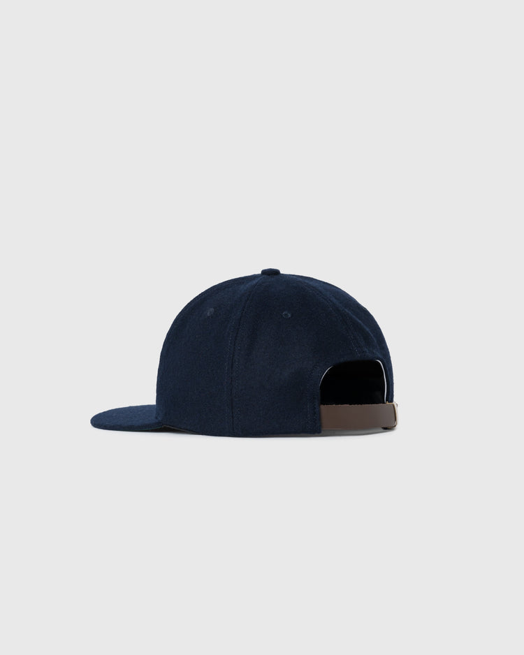 The EFF Cerveceria Polar 1950 Authentic Wool Ballcap is a navy blue vintage hat with a brown adjustable strap, shown from the rear on a light gray background, inspired by the classic Cuban Polar Bear mascot style.