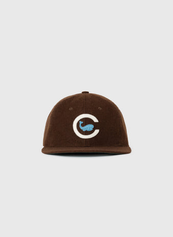 The EFF Chicago Whales 1915 Authentic Wool Ballcap is a vintage brown flat-brim hat with a white C and blue whale logo embroidered on the front, shown against a plain white background.
