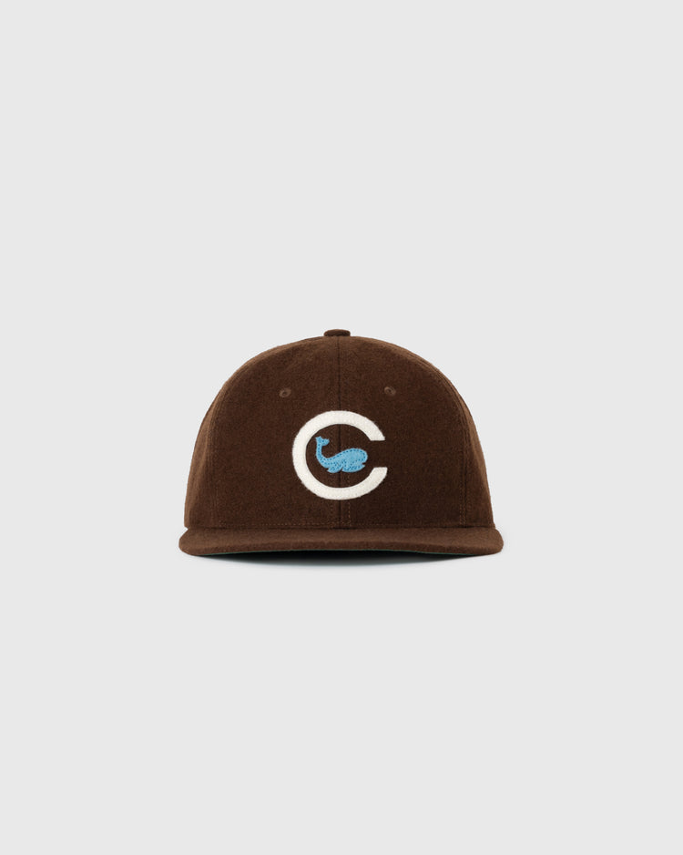 The EFF Chicago Whales 1915 Authentic Wool Ballcap is a vintage brown flat-brim hat with a white C and blue whale logo embroidered on the front, shown against a plain white background.