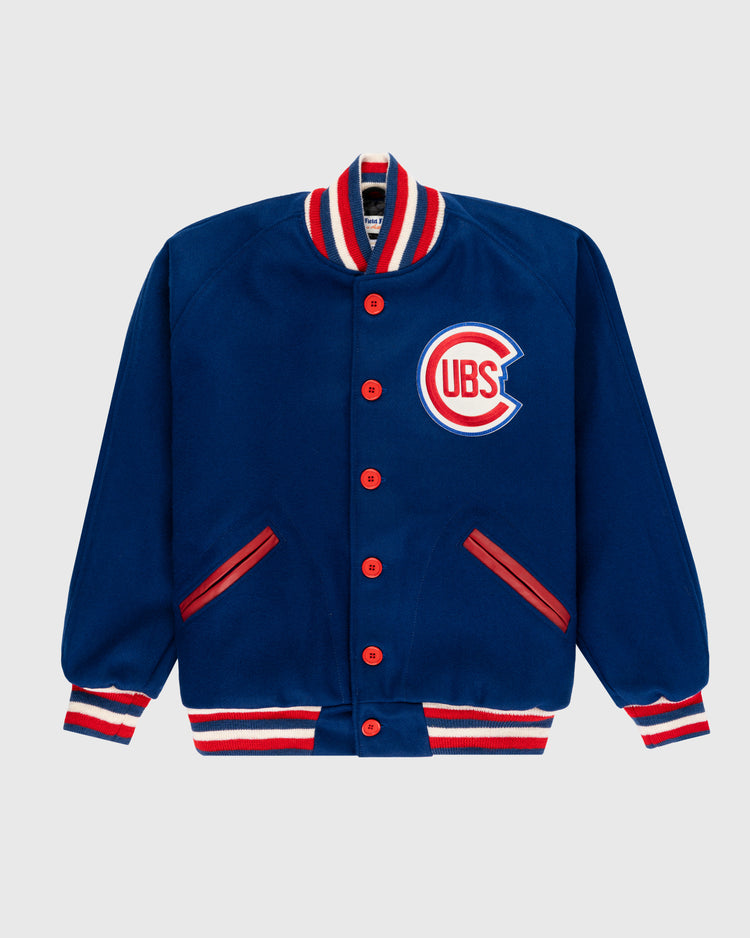 The EFF Chicago Cubs 1954 Authentic All Wool Varsity Jacket is blue with red buttons, red and white striped collar, cuffs, and hem, plus a Cubs logo patch on the left chest.